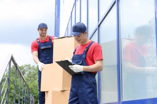 Student removals team handling boxes and furniture in a Notting Hill street