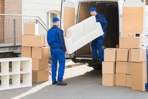 Removal van service team loading household items for transport