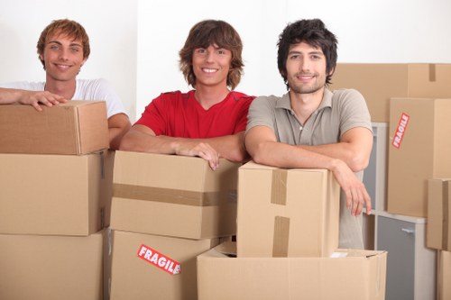 Local moving team handling furniture with a removal van in Notting Hill