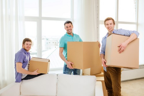 Movers carrying furniture through a London street