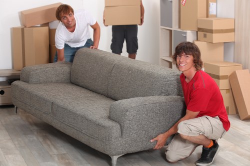 Professional moving team handling boxes with a Notting Hill removal van