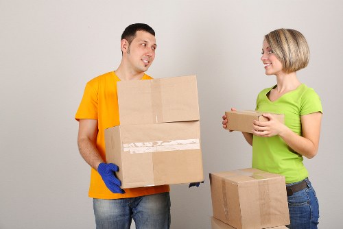 Movers navigating stairs during flat removals in Nottinghill